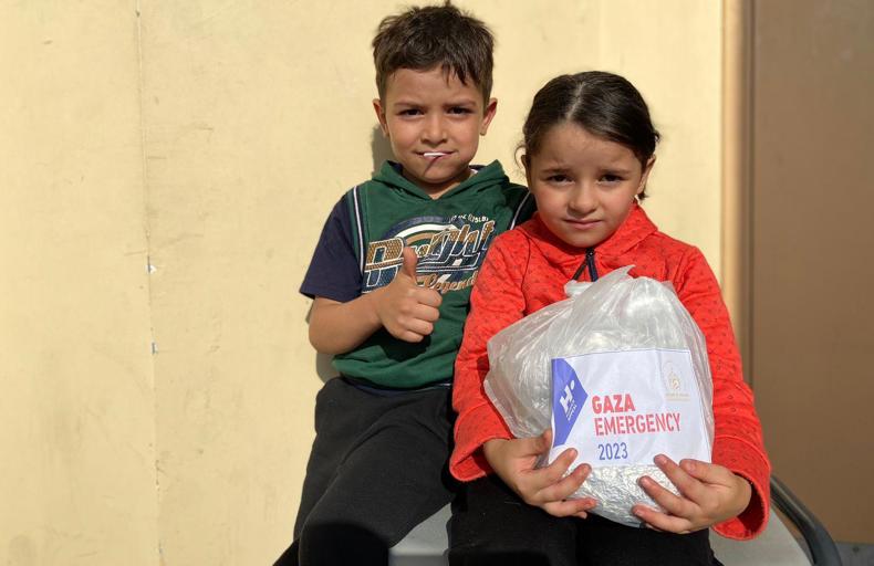 Children holding food parcel