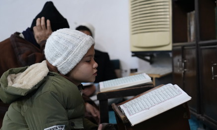 Child reading the Quran