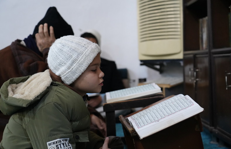 Young boy reading the Qur'an