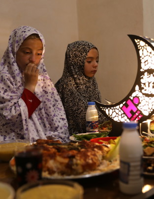 Young girls eating iftar