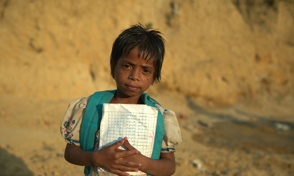 Rohingya child holding paper