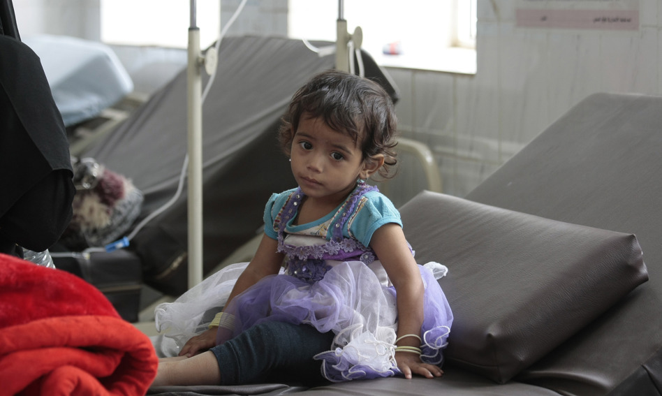 Child sitting on a bed in a clinic