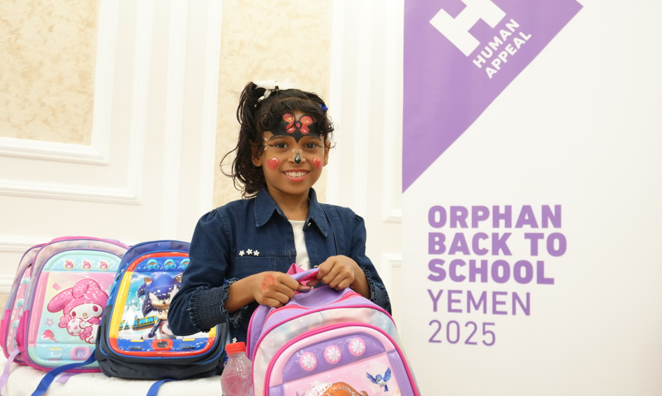 Young girl holding a back to school kit bag