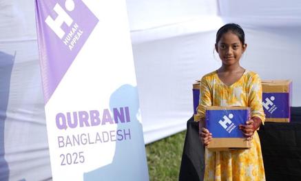 Child holding Qurbani box