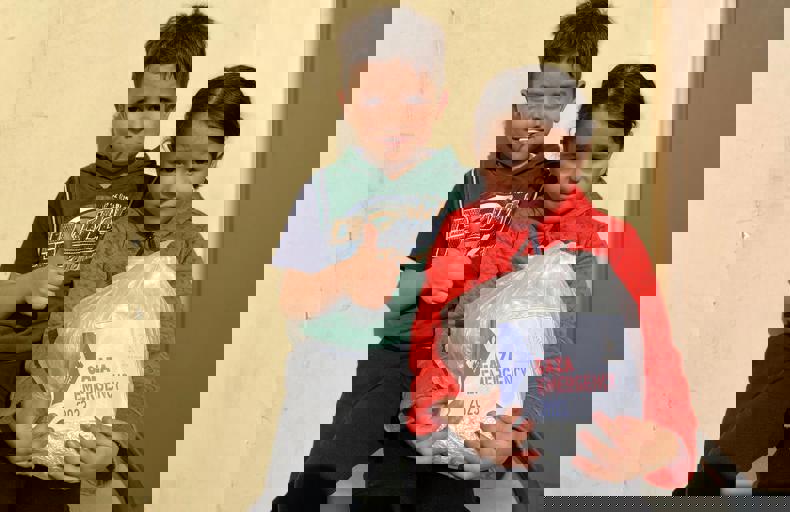 Children holding food parcel