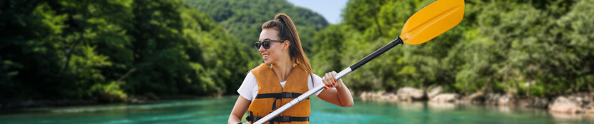 Woman wearing a lifevest with oar or paddle in a river