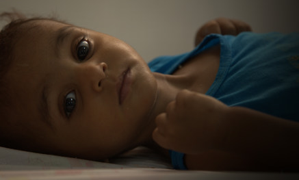 Child laying on bed