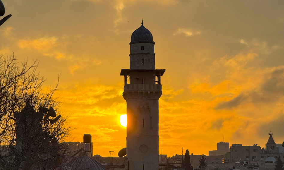 Minaret silhouetted against sunlight
