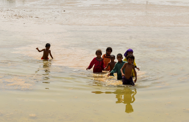 Pakistani children submerged in water