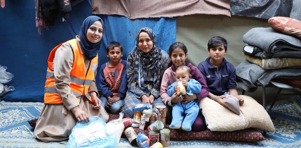 Family receiving a food parcel in Gaza