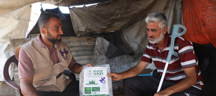 A member of our staff providing a Qurbani package.