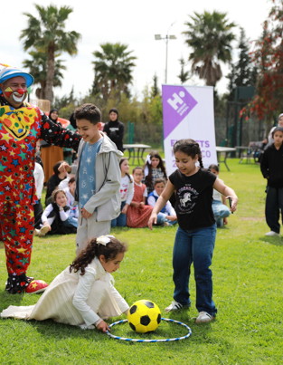 Children at an Eid party with a clown