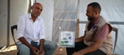 A member of our staff chatting with a recipient of Qurbani. 