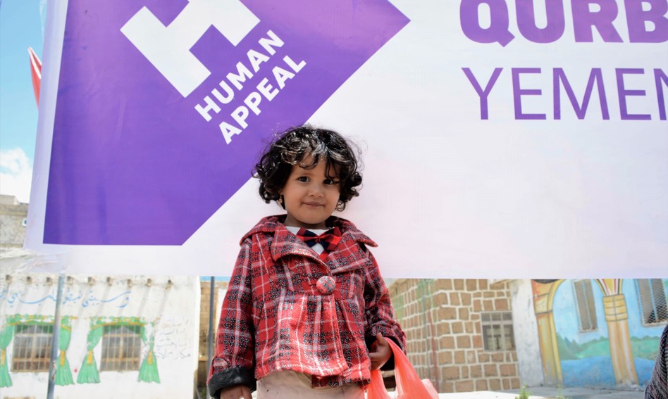 Child holding Qurbani bag