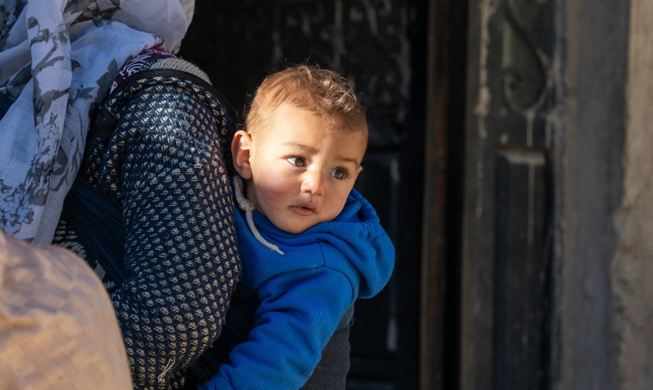 Woman carrying young boy in Morocco