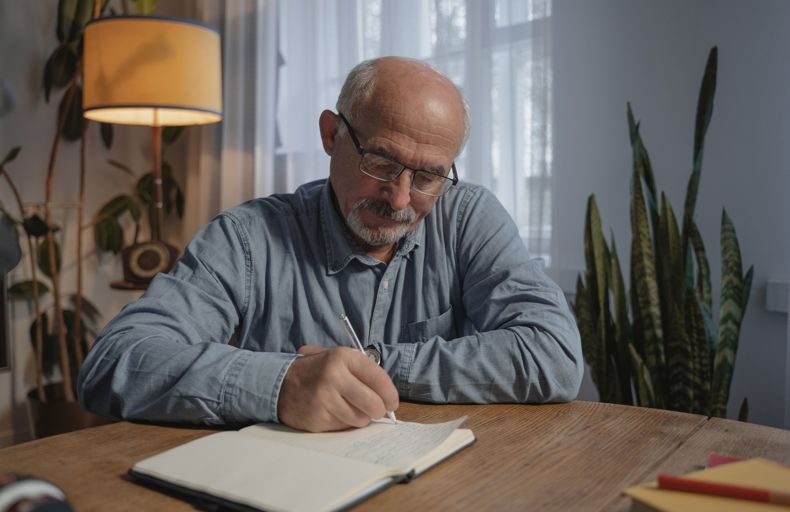 Man writing his ill. Photo by Tima Miroshnichenko via Pexels. 