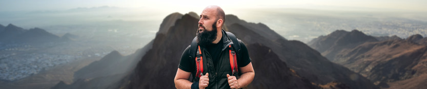 Man backdropped by a mountain