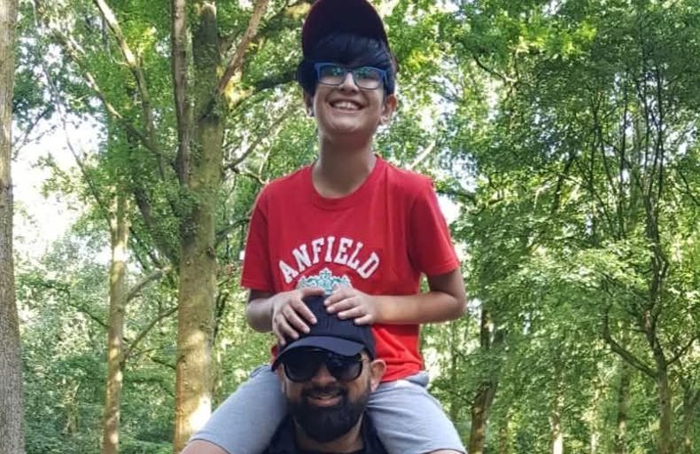 Zaheer's son riding on his father's shoulders