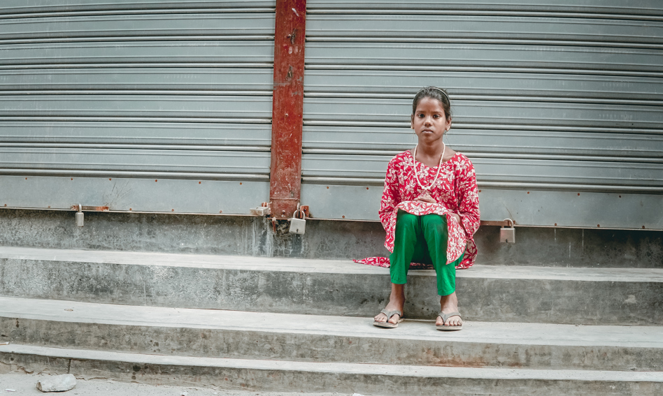 Young girl sitting on a step