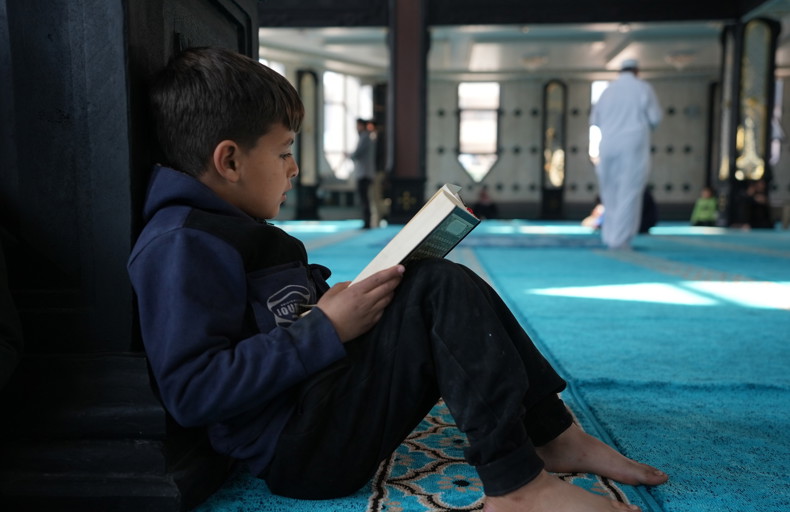 Child reading a book, learning about what breaks a fast