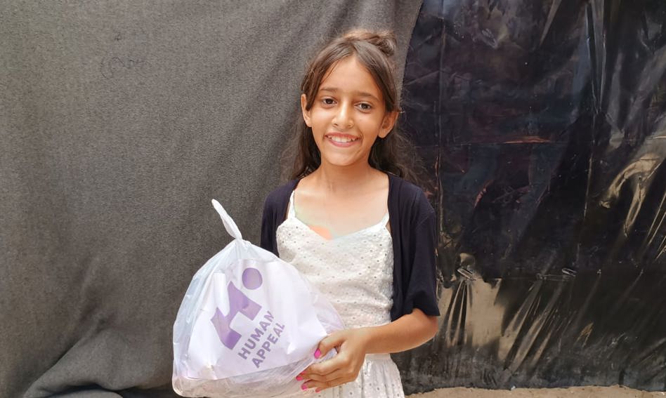 Child holdin Qurbani bag