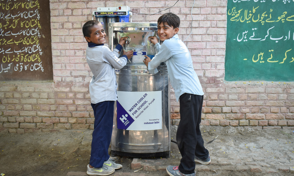 Children using a water cooler
