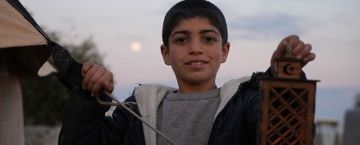 Young boy holding a lantern