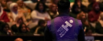 Human Appeal staff member amid a crowd at the Comedy Tour