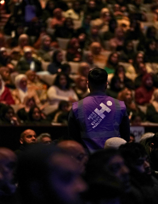 Human Appeal staff member amid a crowd at the Comedy Tour
