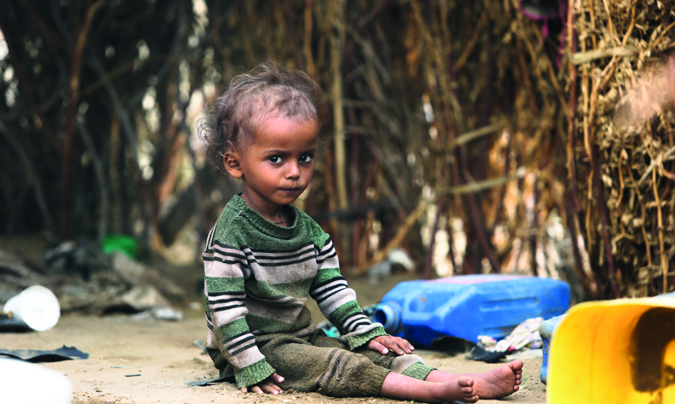 Child sitting on the ground in Yemen