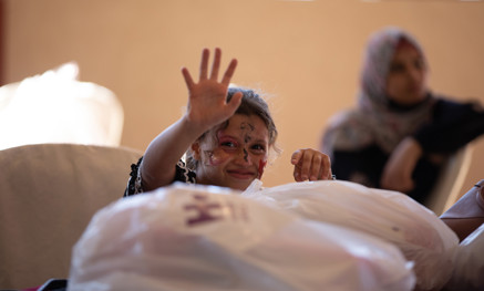 Child waving over gift parcel