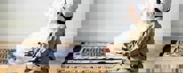 A child praying alongside his parent