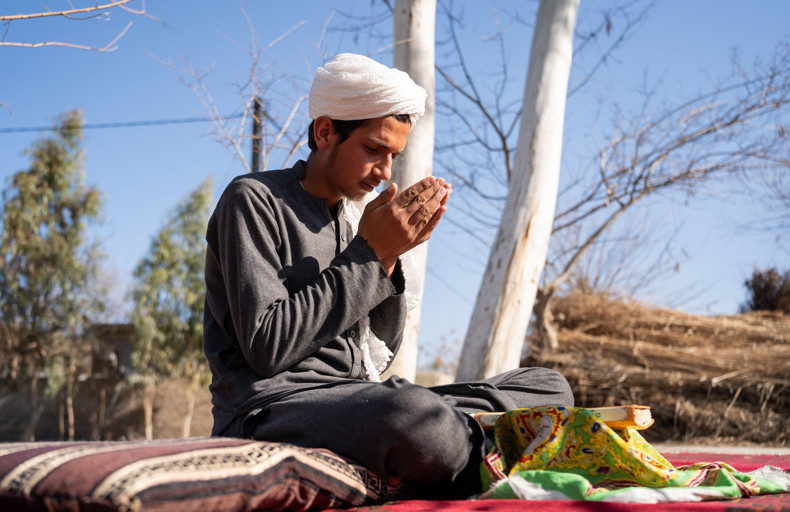 Man praying during Rabi al-Awwal