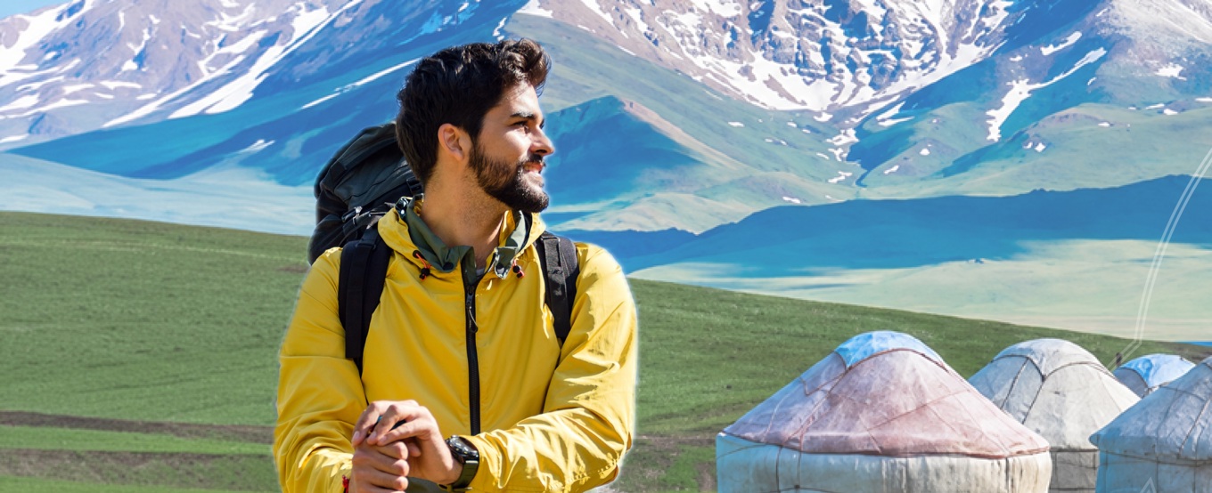 Man with backpack, with mountains in the background