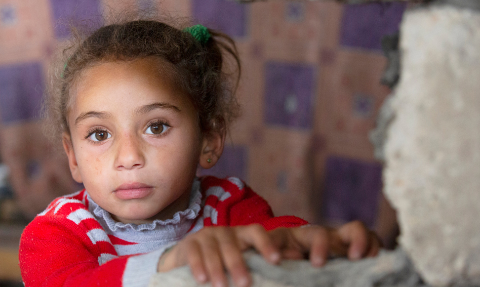 Child looking out past a destroyed war
