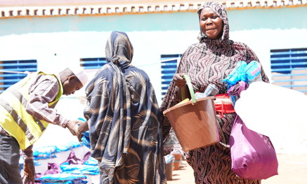 Sudanese women holding buckets