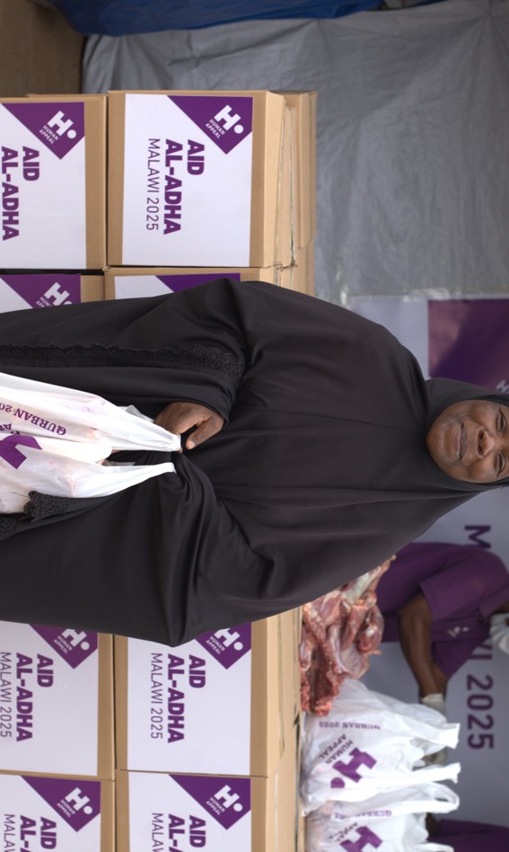 Woman holding Qurbani bag