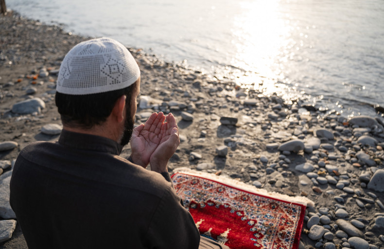 Man making dua to increase in Taqwa next to the shore
