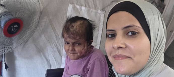 Our field worker with Reema during a home visit.