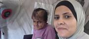 Our field worker with Reema during a home visit.